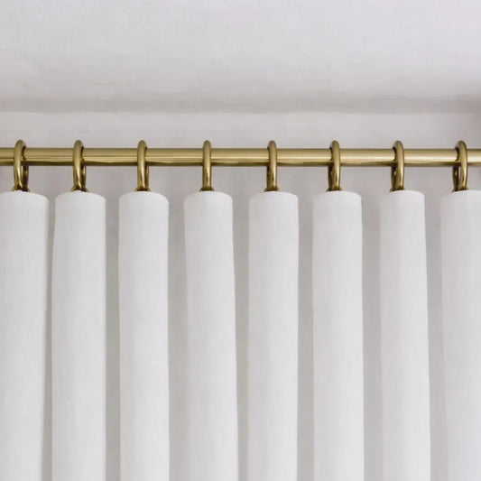 brass shower curtain rod neutral bathroom styling