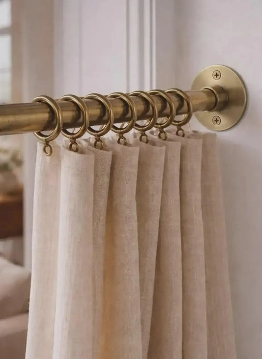 brass shower curtain rod with beige curtains