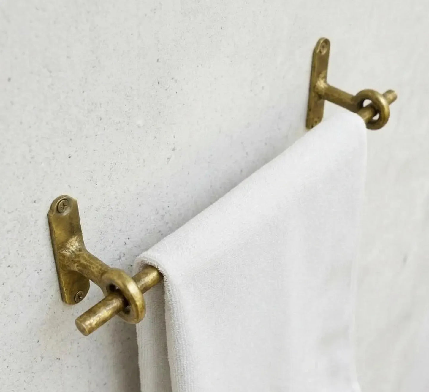 Unlacquered brass towel bar with ring supports