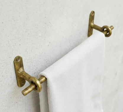 Unlacquered brass towel bar with ring supports