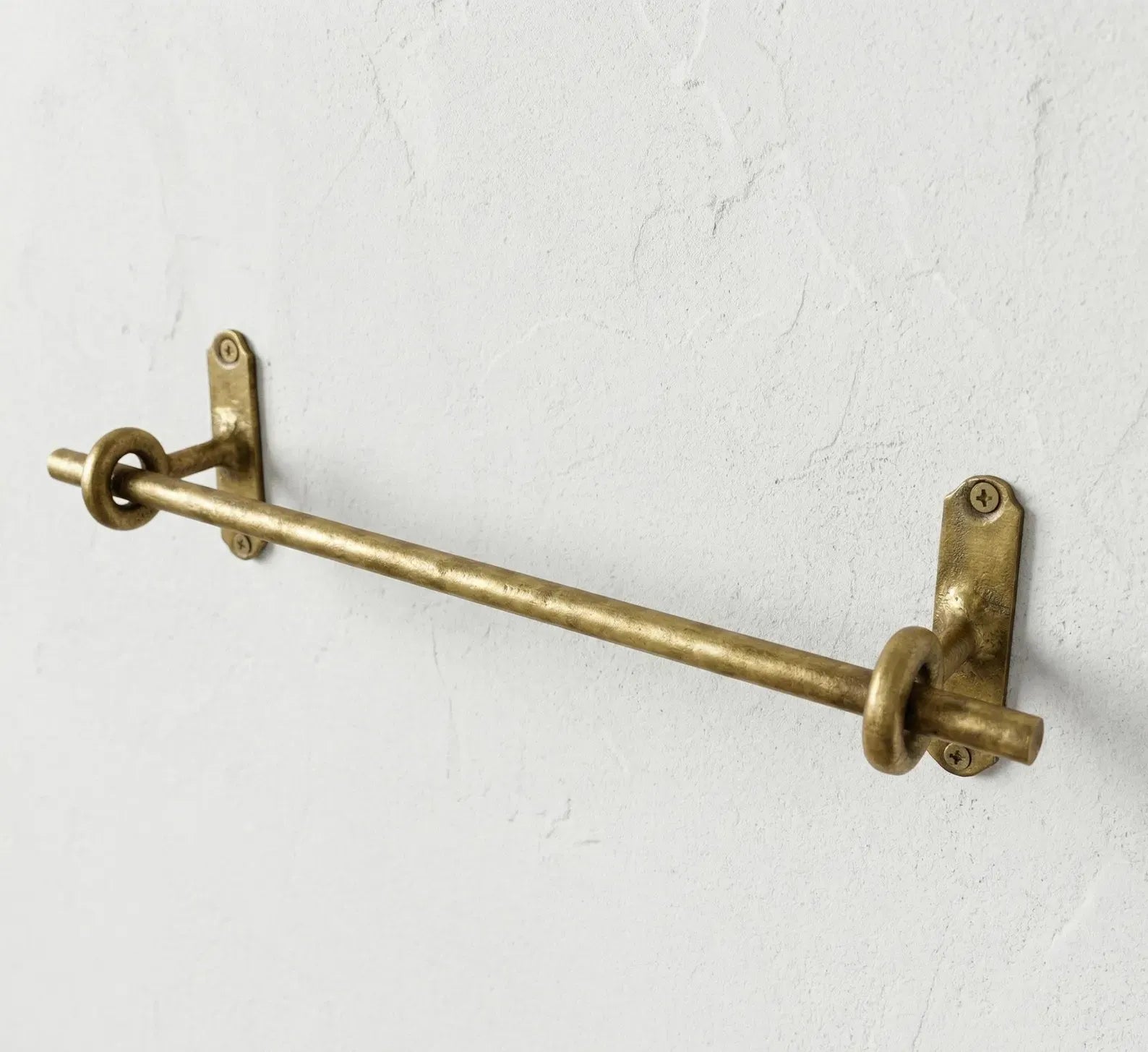 Unlacquered brass towel bar with ring supports