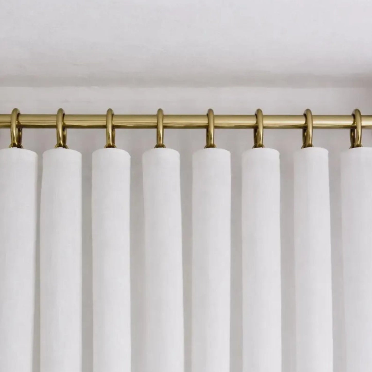 brass shower curtain rod neutral bathroom styling