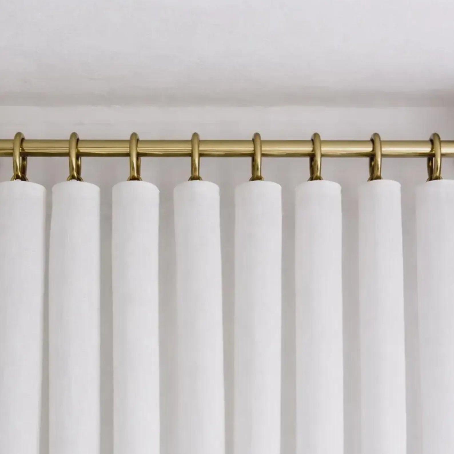brass shower curtain rod neutral bathroom styling