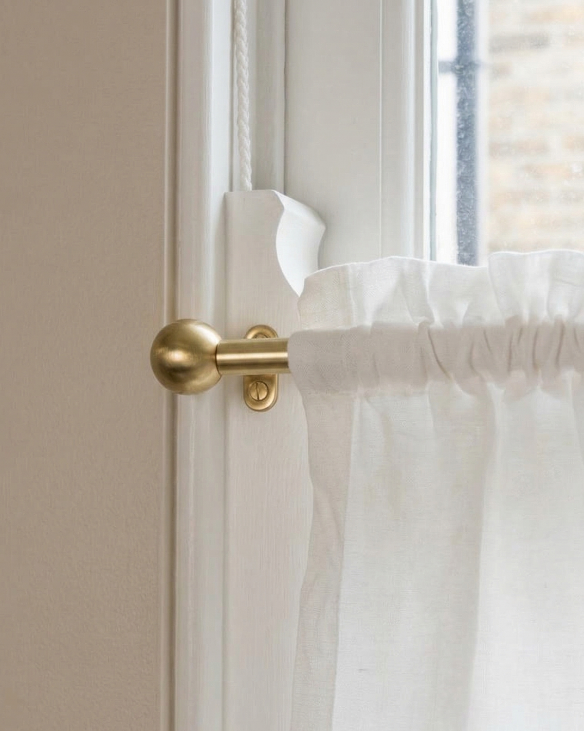 brass window rod with decorative finials