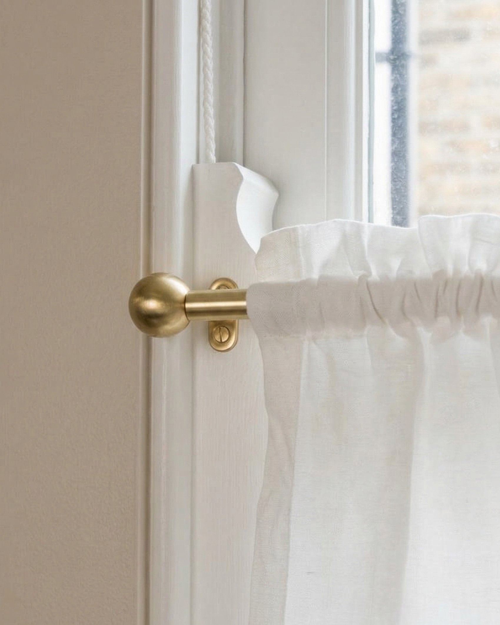 brass window rod with decorative finials