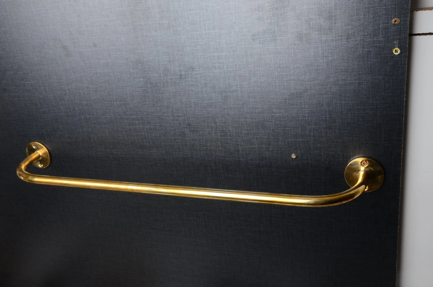handcrafted brass curtain rod installation