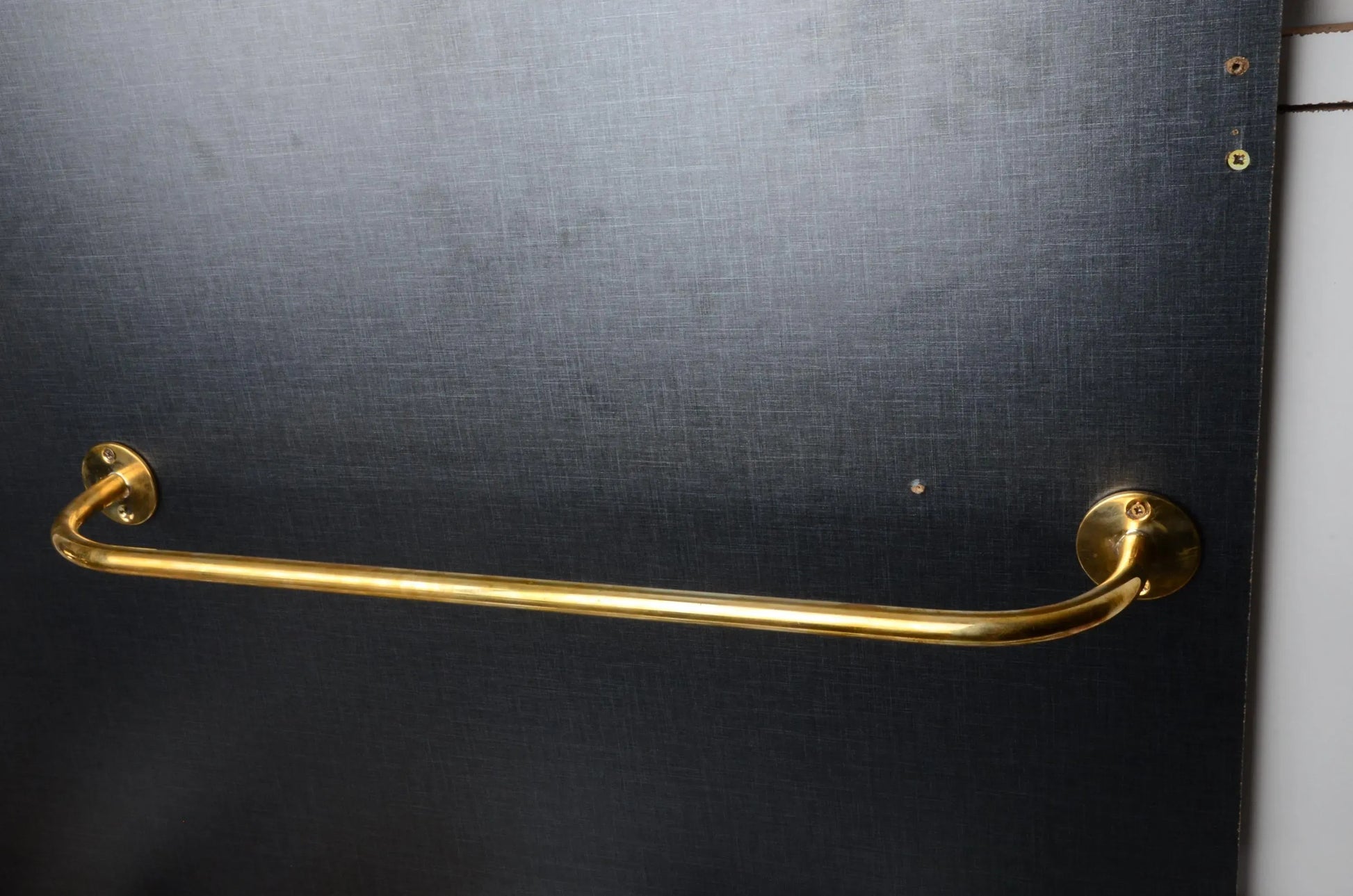 handcrafted brass curtain rod installation