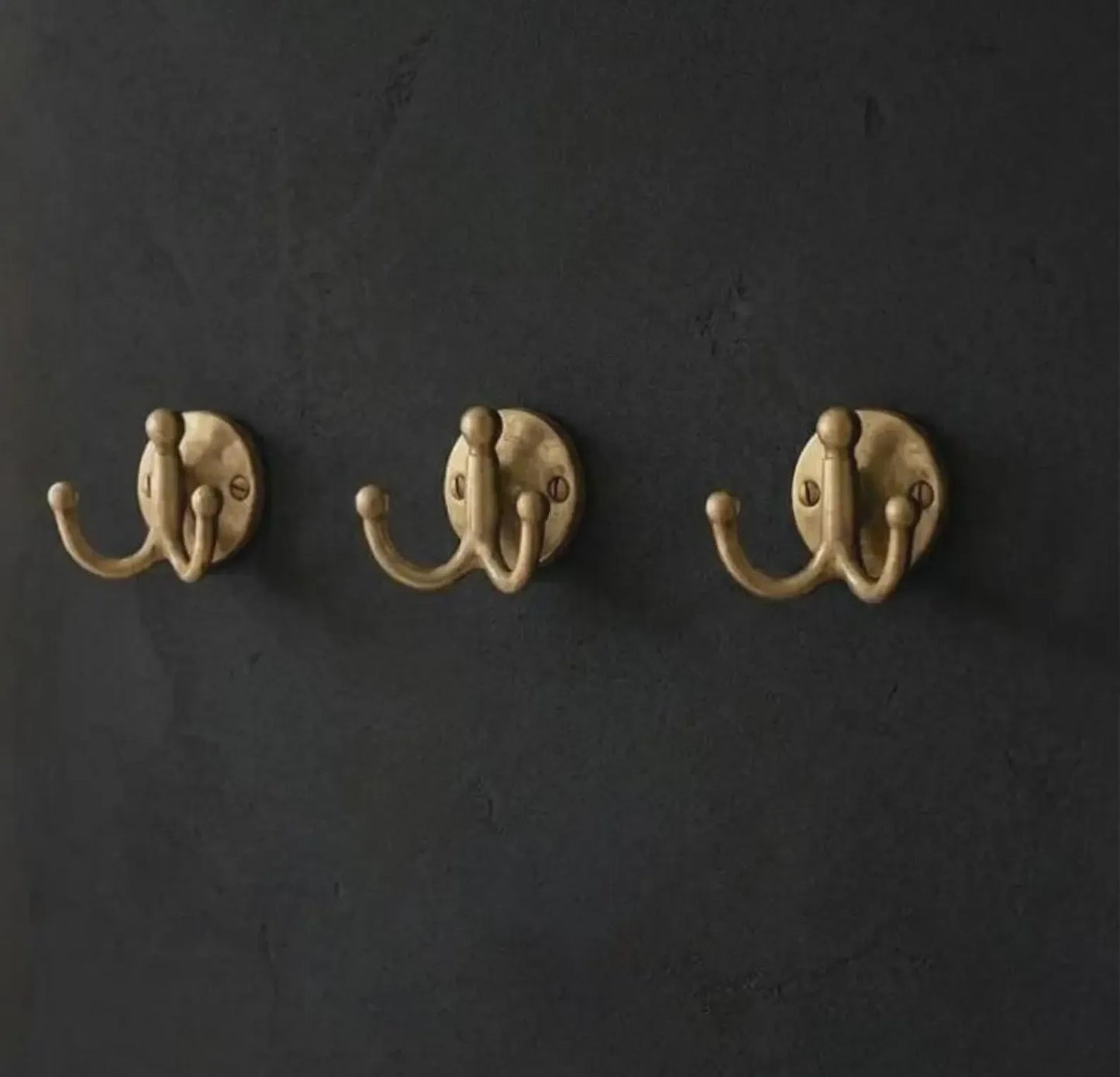 handcrafted brass double hook close up