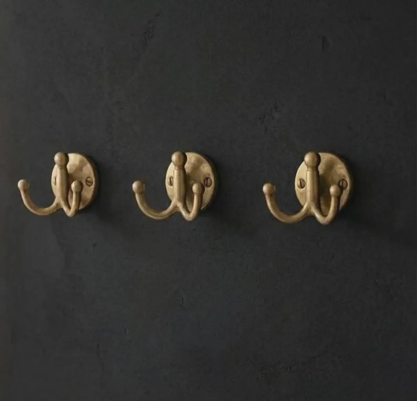 handcrafted brass double hook close up